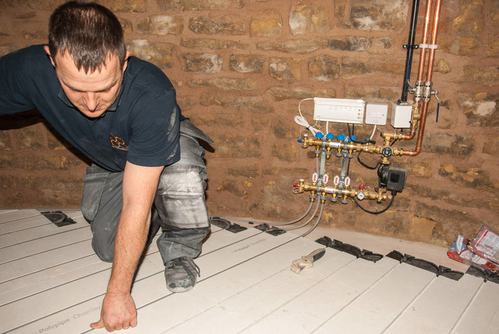 Installing underfloor heating pipes