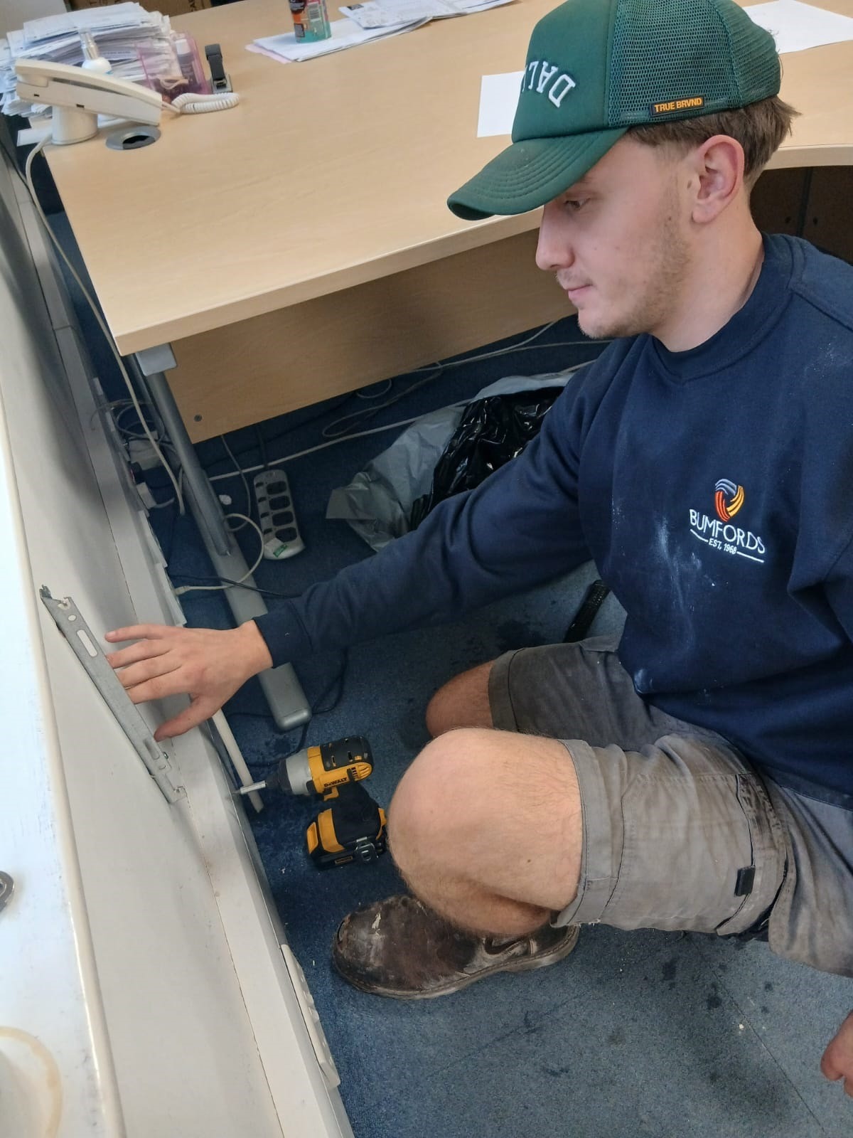 Bumfords engineer installing and checking a radiator