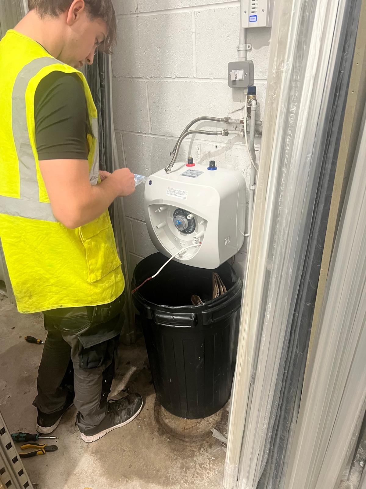 Bumfords engineer installing water-heating equipment and associated pipework
