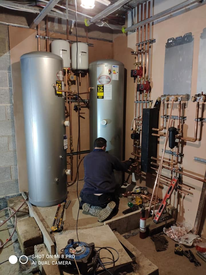 Bumfords engineer working on a hot-water cylinder installation